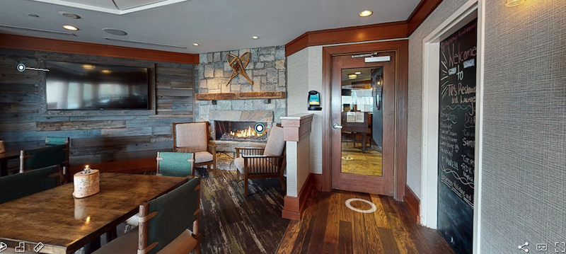 fireplace, tables, chairs at trs restaurant at holiday inn resort in Lake George